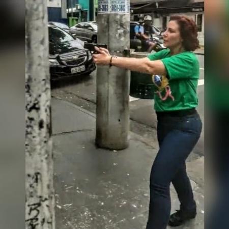 Carla Zambelli, em outubro de 2022, empunhando arma durante discussão em São Paulo.